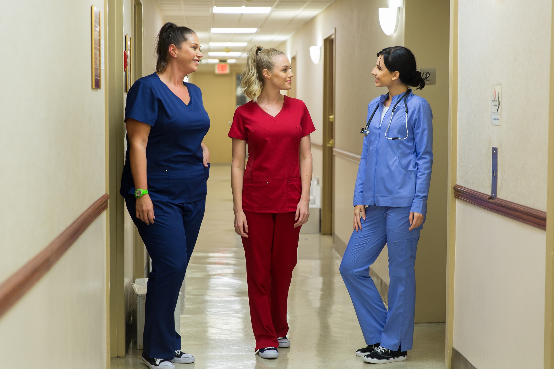 3_nurses_scrubsstyle_looking_at_each_other